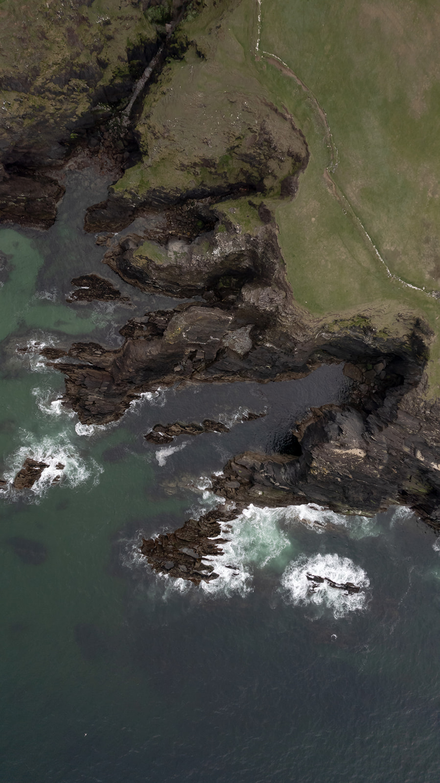 Dark Irish cliffs and coast line from a bird perspective.