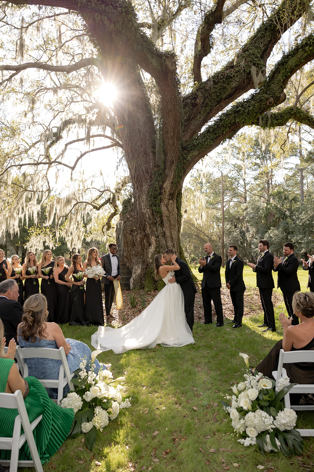 Bride and groom kissing unde roak tree at Magnolia Plantation Wedding