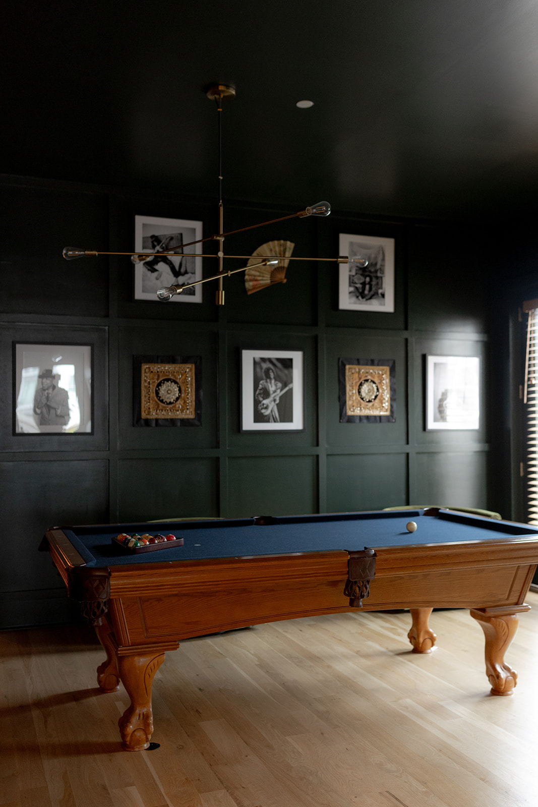 Pool table in Charleston Airbnb with picture wall in the back