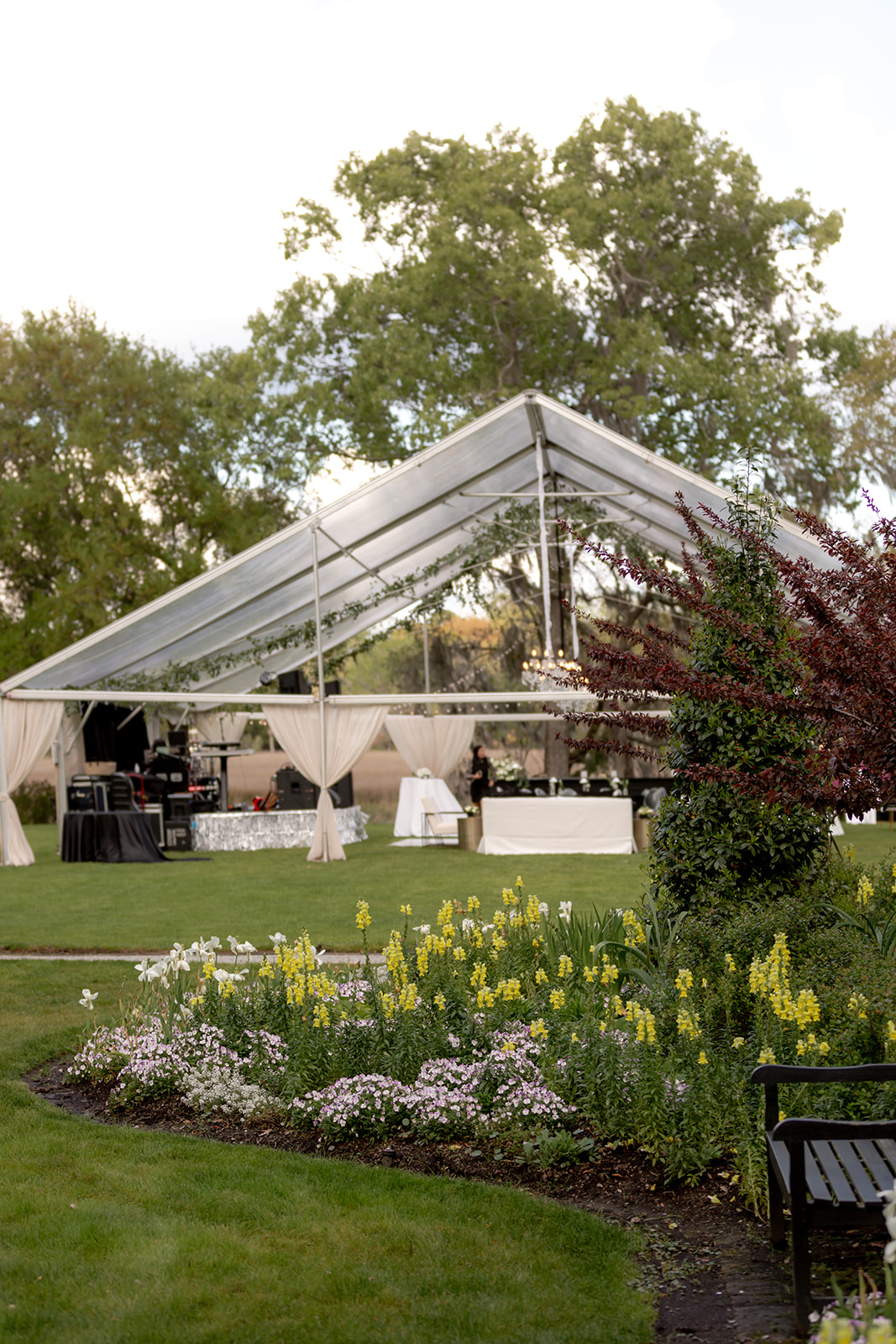 Clear top tent at Magnolia integretaed in garden with flowers and trees