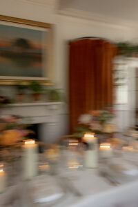 Artsy photo of reception table with candles and flowers.