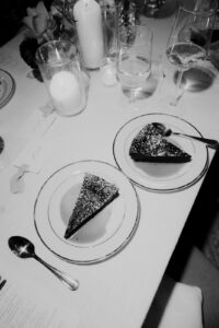 black and white photo of wedding cake slices served at Wedding at the Post House