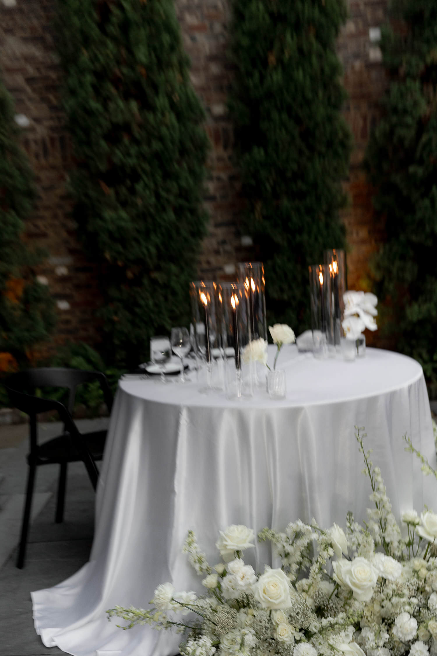 Sweetheart table at a Dewberry wedding with candles and white flowers