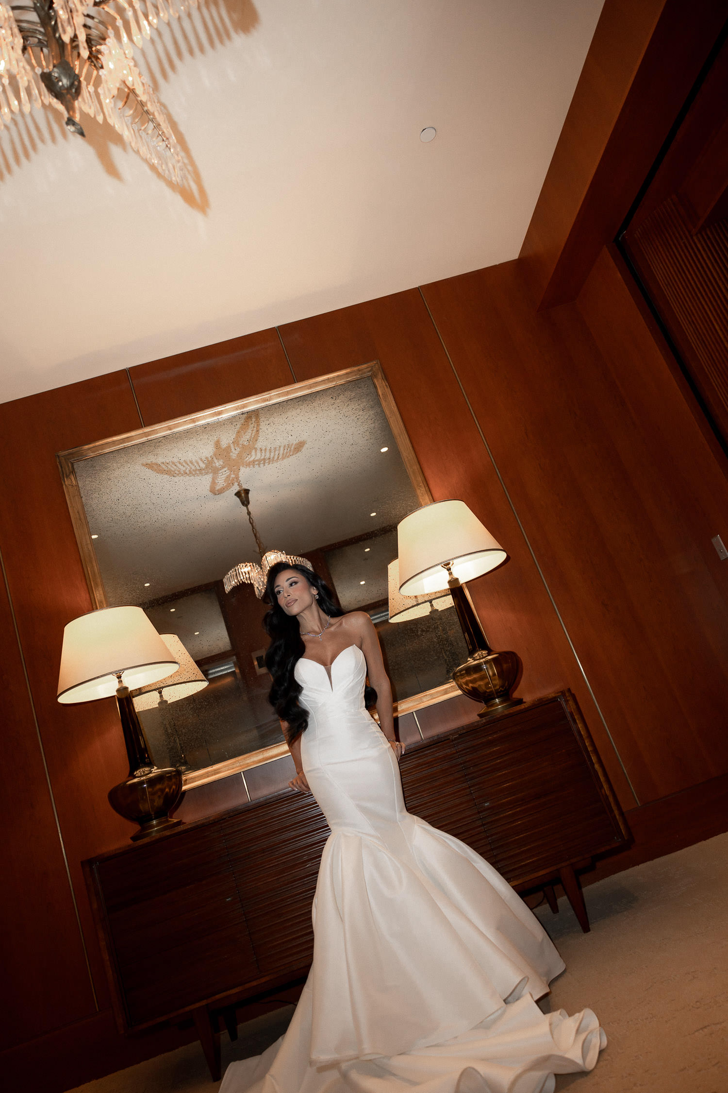 Bride standing in front of mirror in Dewberry hallway