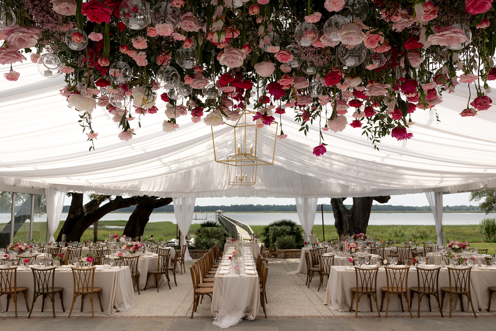 Beautiful decorated reception area at Lowndes Grove wedding with red and pink flowers. Flower arrangement hanging from ceiling