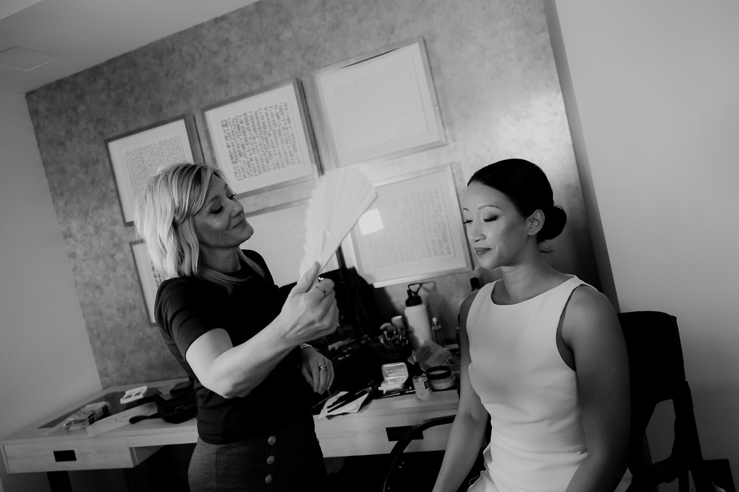 Makeup artist makes final touches on bride before wedding at Alexander Homestead