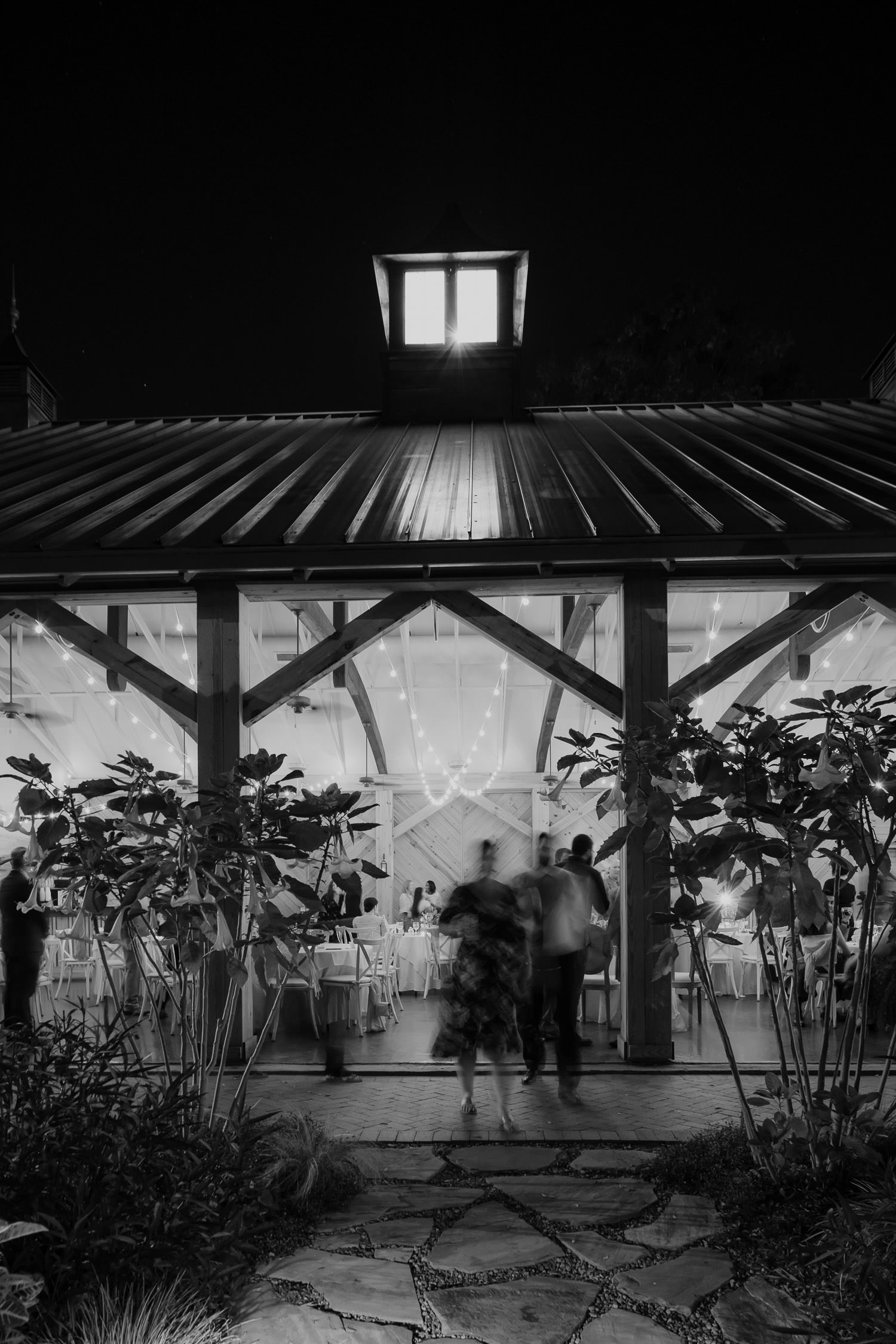 artys photo of wedding at Alexander Homestead with all barn doors open during reception