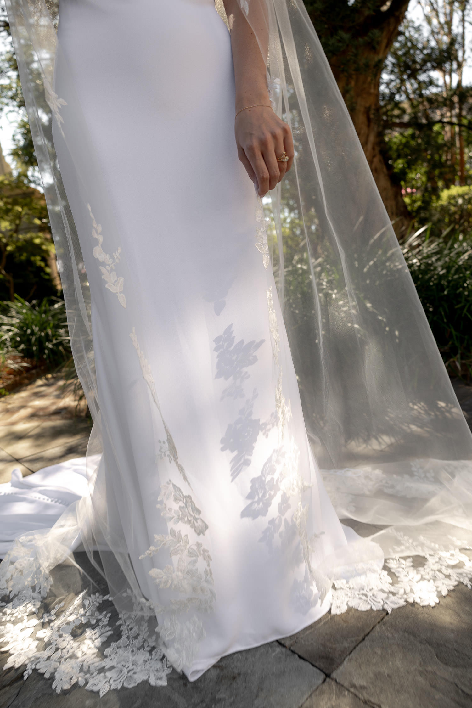 close-up photo of bridal dress hit by sun beams highlighting the elegant fabric