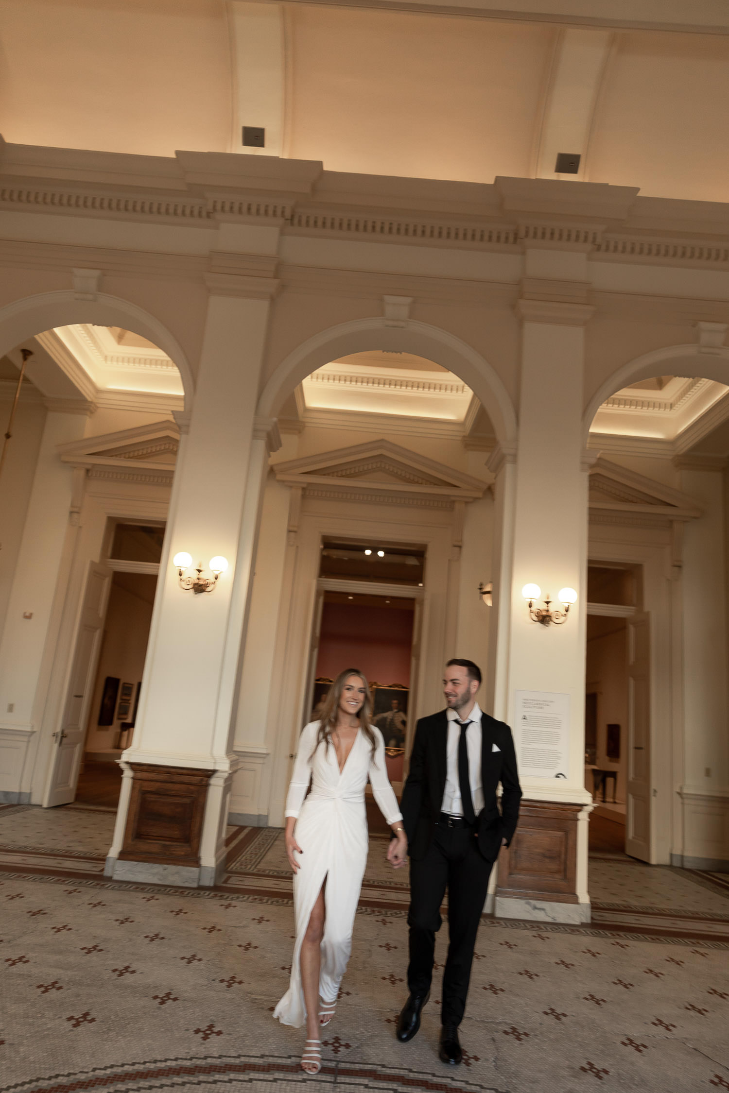 Couple walking in the rotunda during Gibbes Museum Engagement session in Charleston