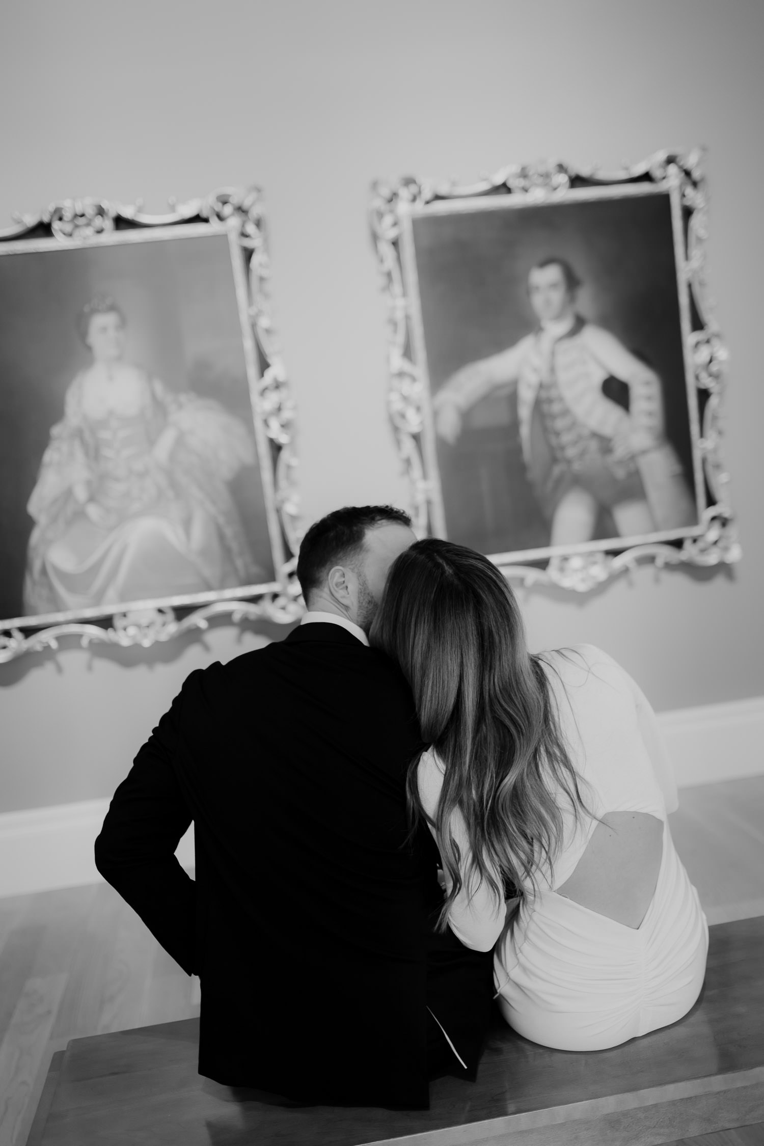 Man and woman leaning into each other during Gibbes Museum Engagement. Captured from behind in black and white