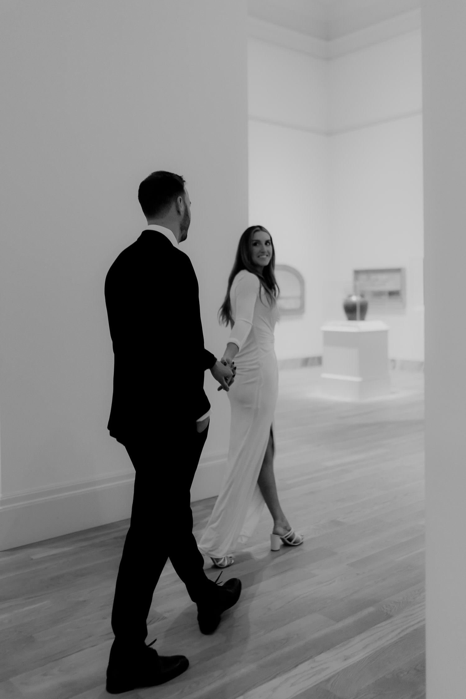 Woman leading man in black suit through the gallery at the Gibbes Museum in Charleston 