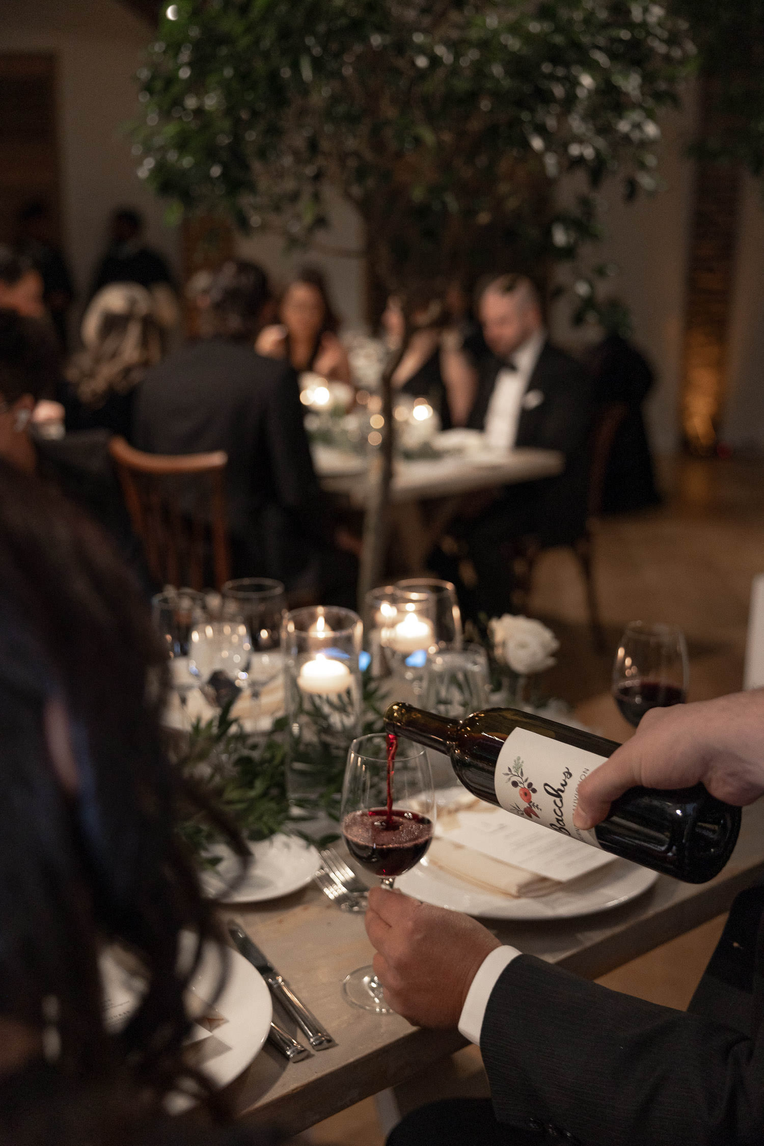 Waitress serving wine at wedding reception at Cannon Green during Winter Wedding in Charleston