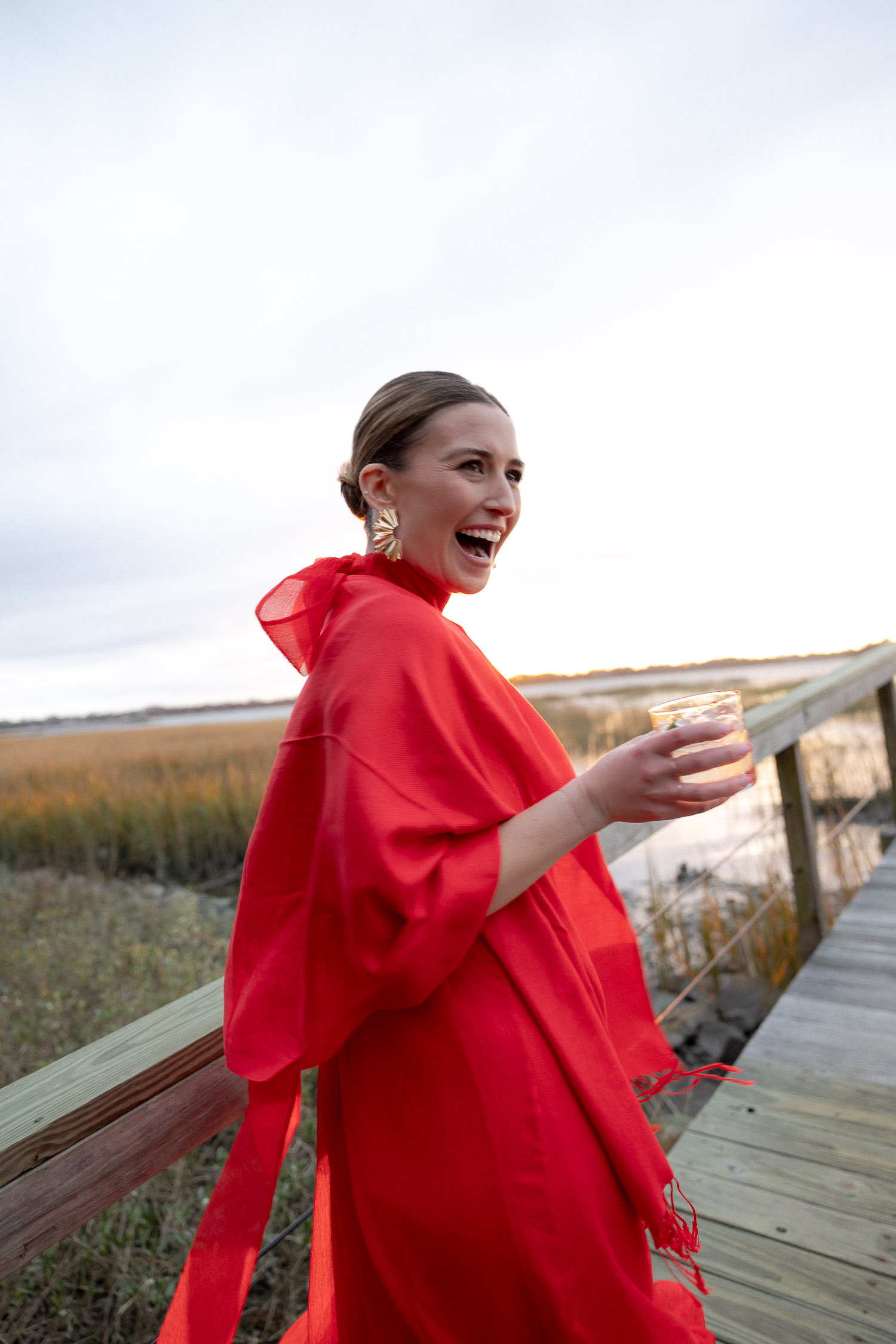 Bridemaid in red dress walking pier at Lowndes Grove