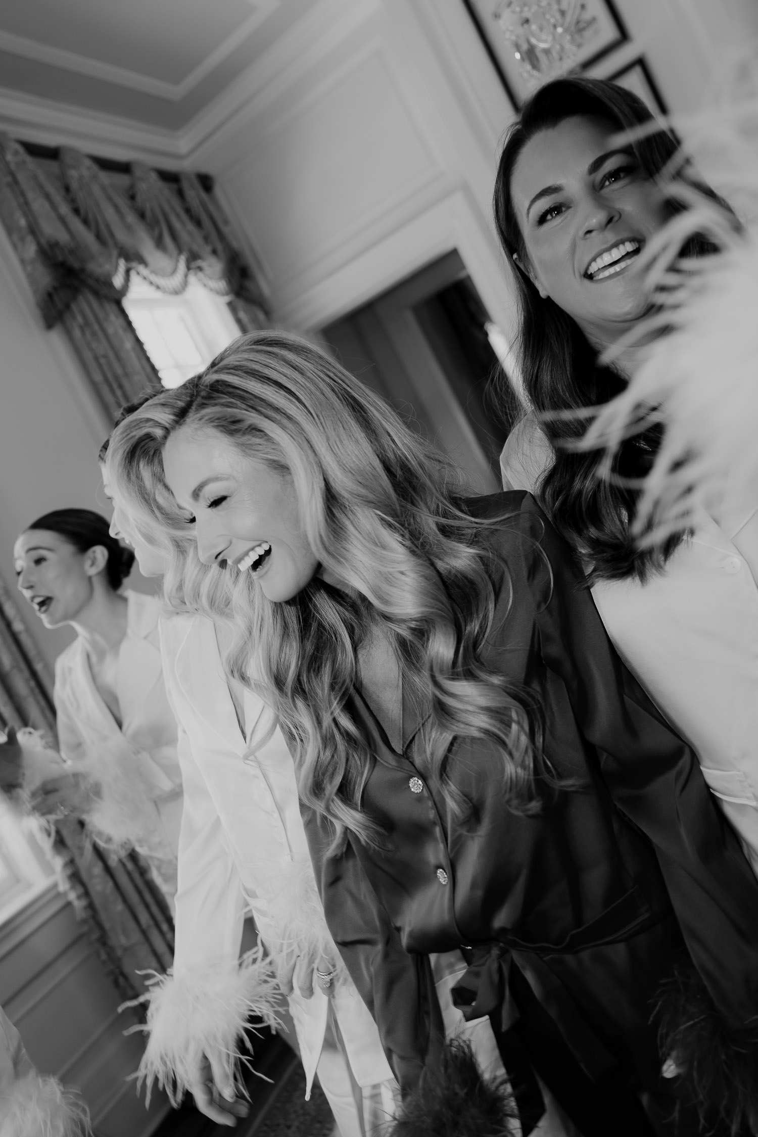 Black and white photo of Bride with bridemaids getting ready for Hot pink & Red wedding