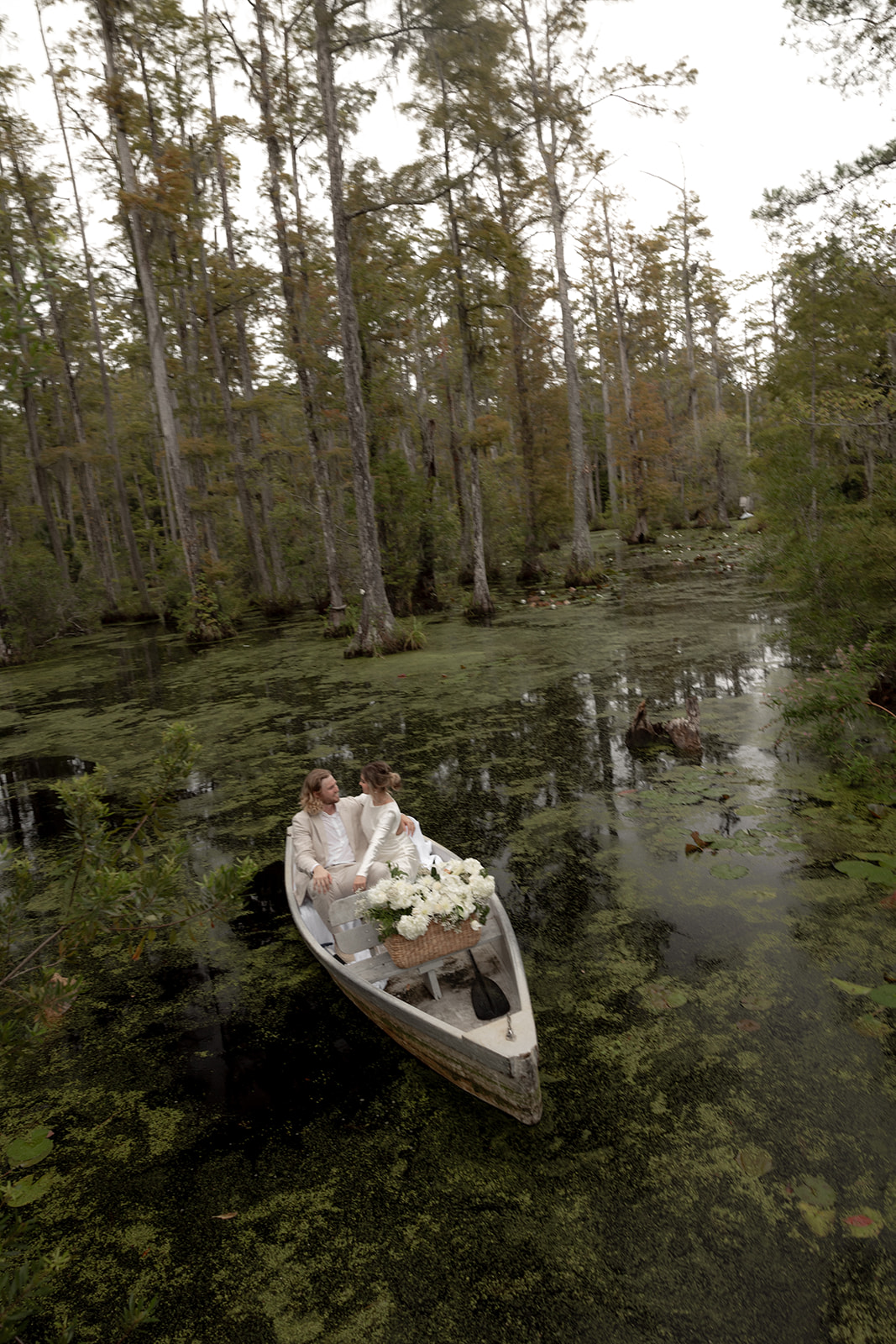 Cypress Gardens Elopement. Couple floating on serene blackwater swamp