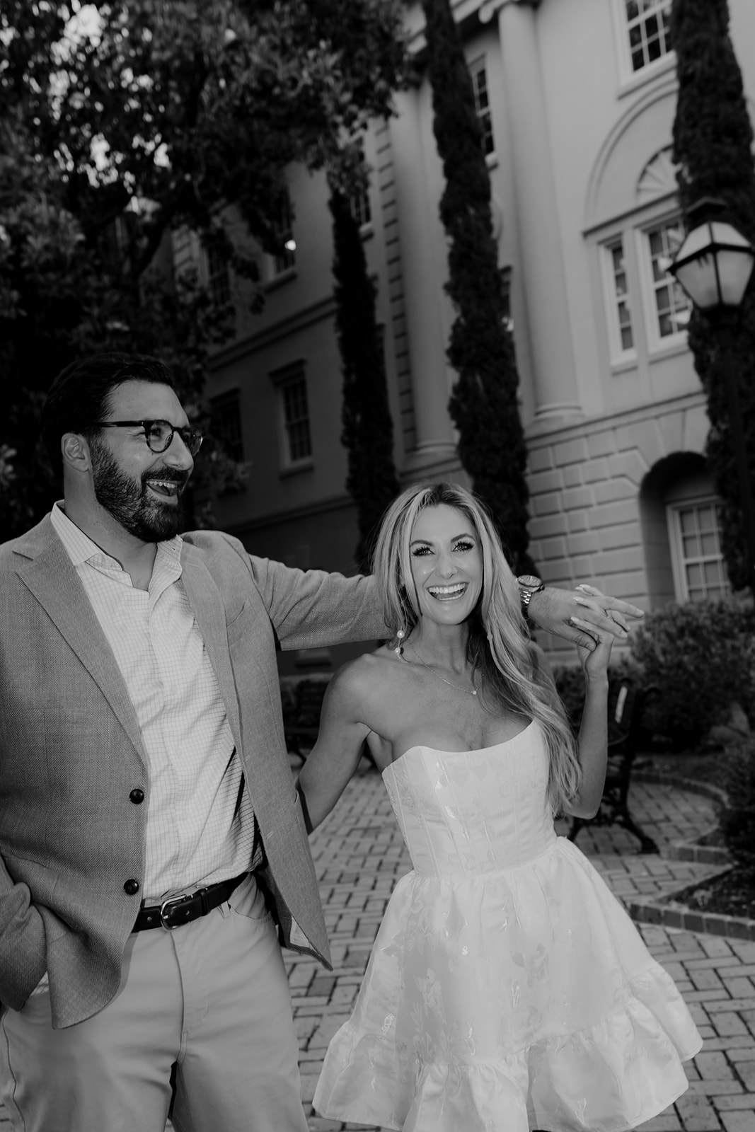 Black and white photo of couple laughing during Downtown Engagement session in Charleston