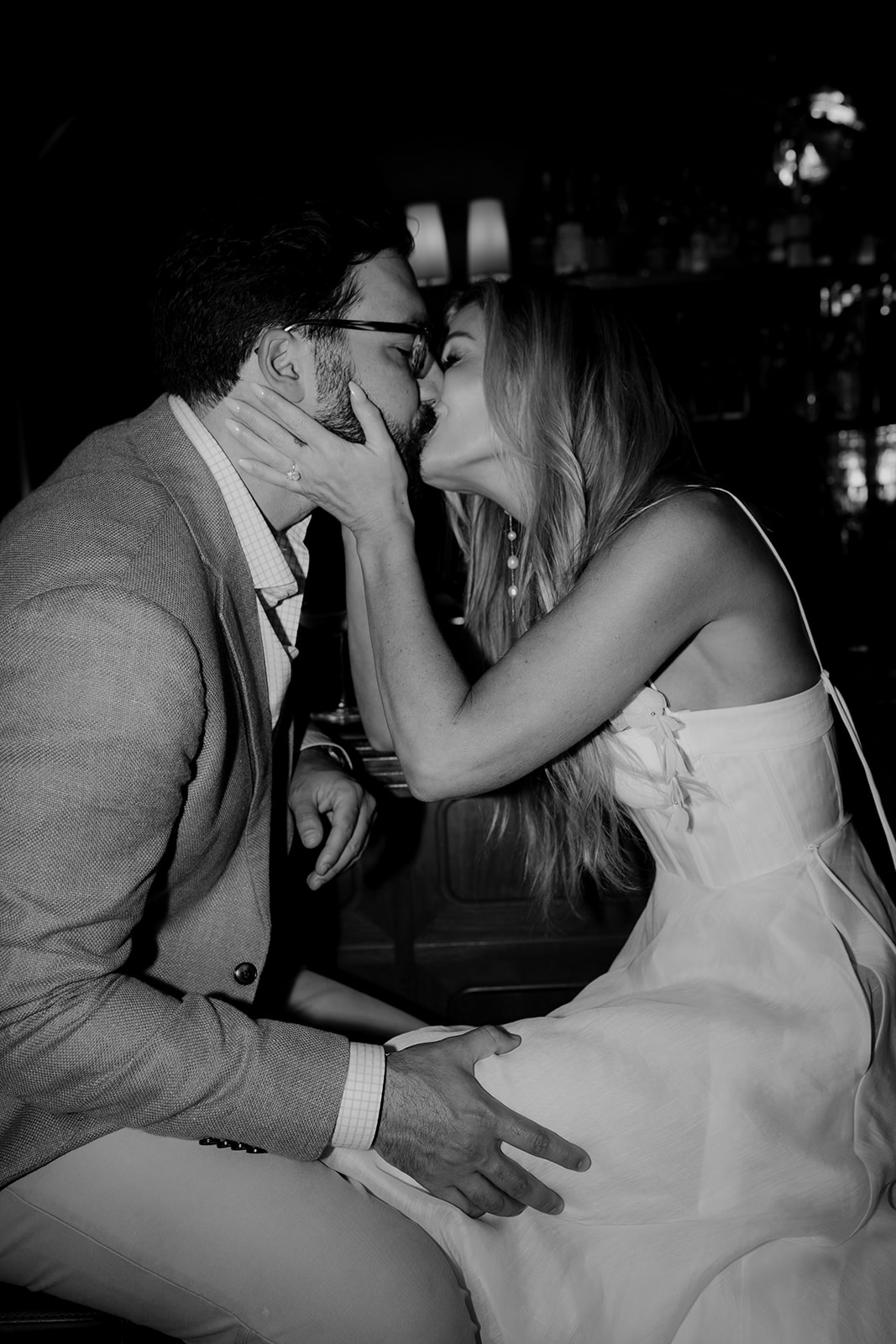 Black and white engagement session photo of couple kissing captured at The Palmetto Lobby Bar