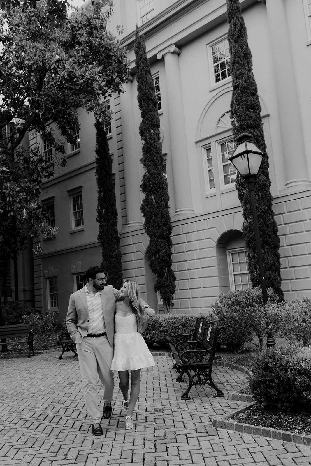 Couple in love walking. Man puts arm around woman. Photo captured at Downtown Engagement photo session