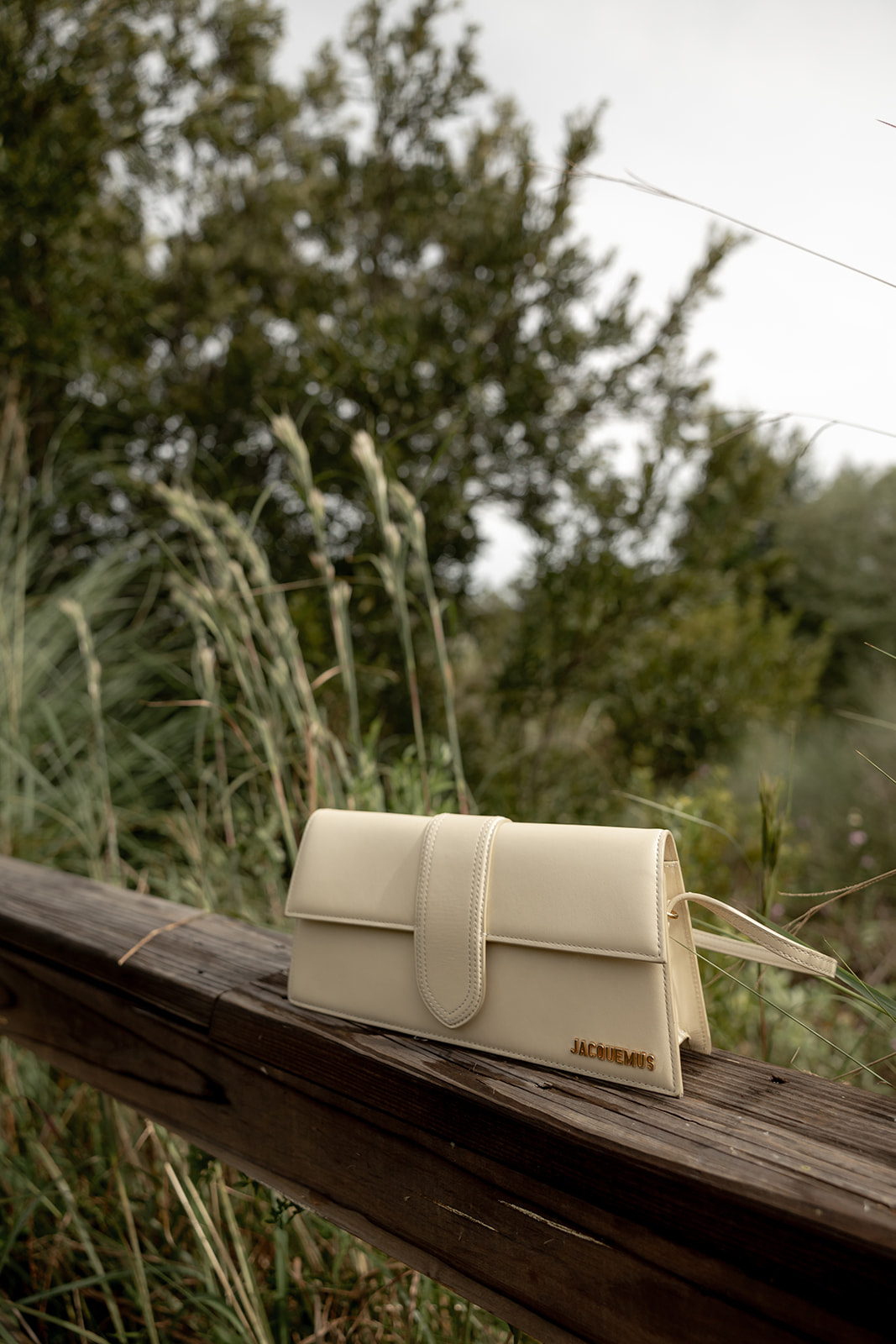 Handbag on wooden railing at Isle of Palms placed during engagement photo session