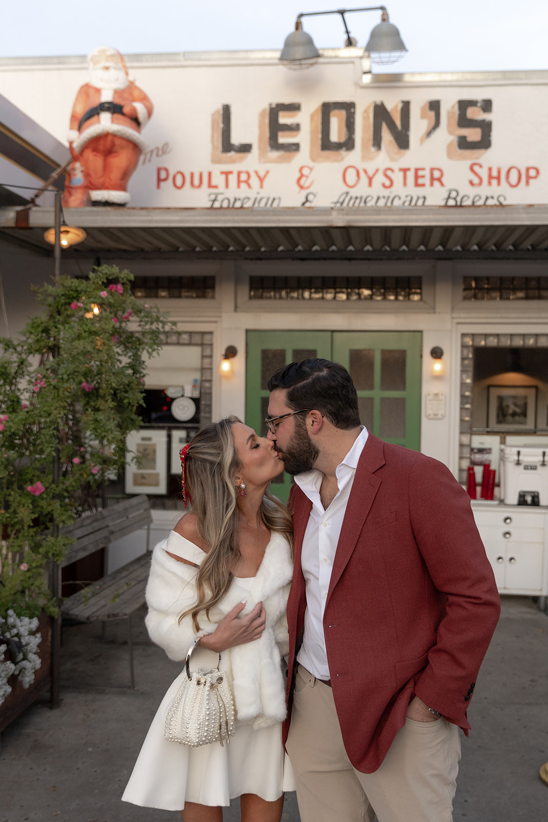 Bride and groom share a kiss in front of  Leon's Oyster Shed