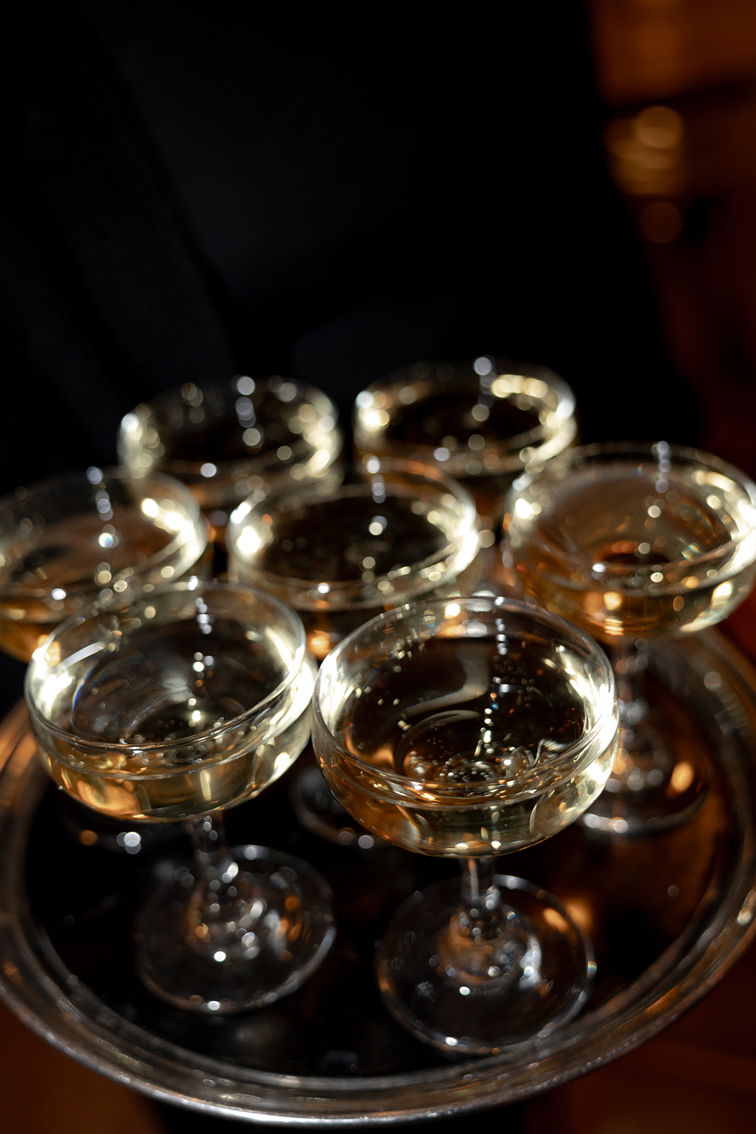 Champagne glasses on a waitress drinks tray at Rehearsal Dinner at Parcel 32