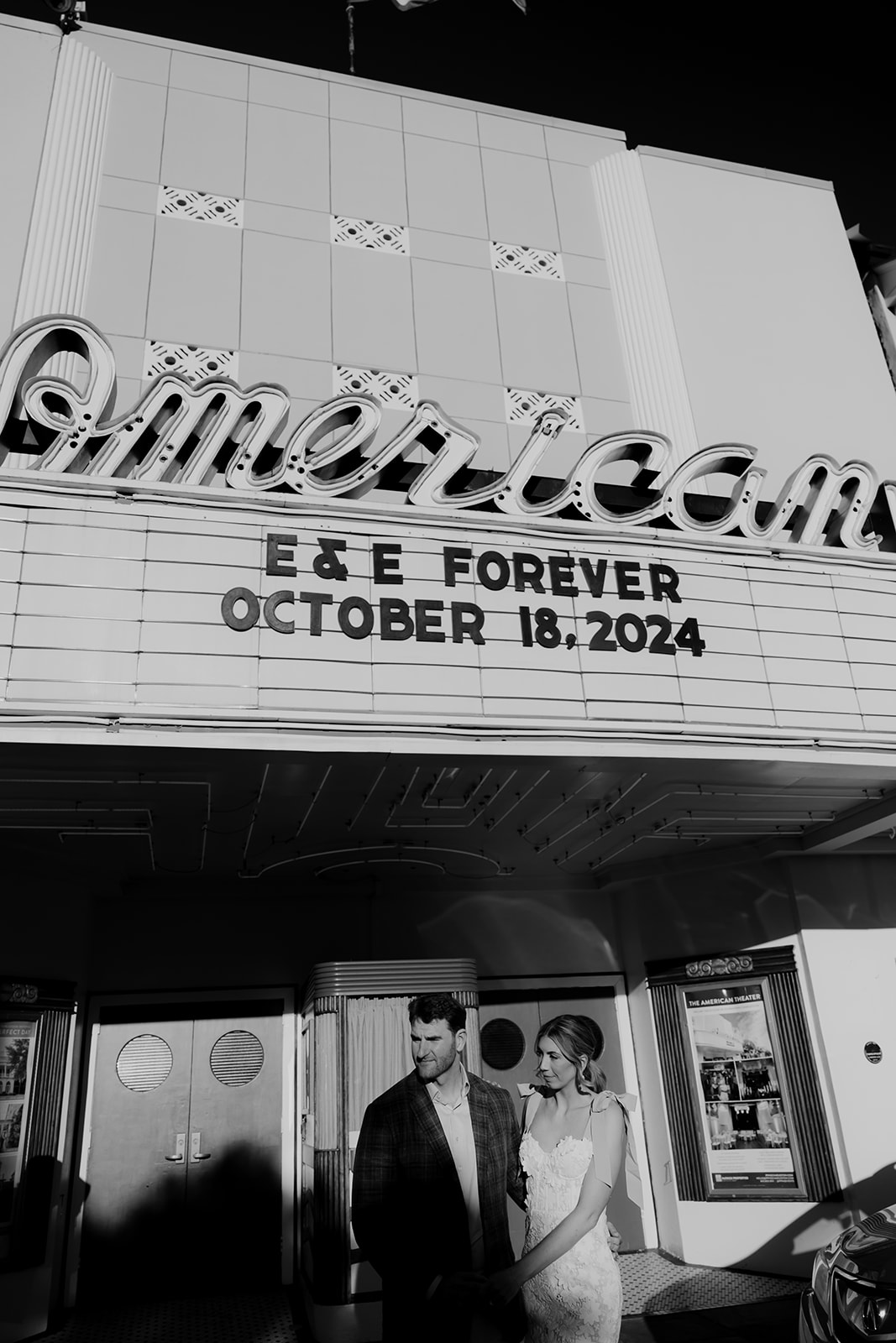 Couple posing under American Theatre with personalized message during Rehearsal Dinner at Parcel 32 in Charleston