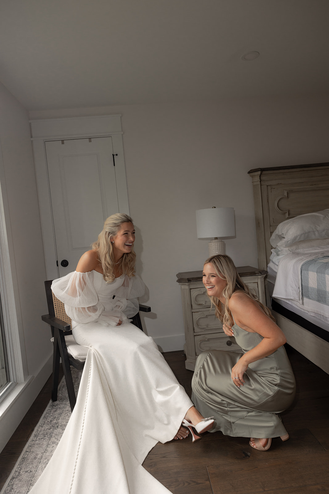 Bride getting ready for Middleton Place Wedding. Bridesmaid helping to put shoes on