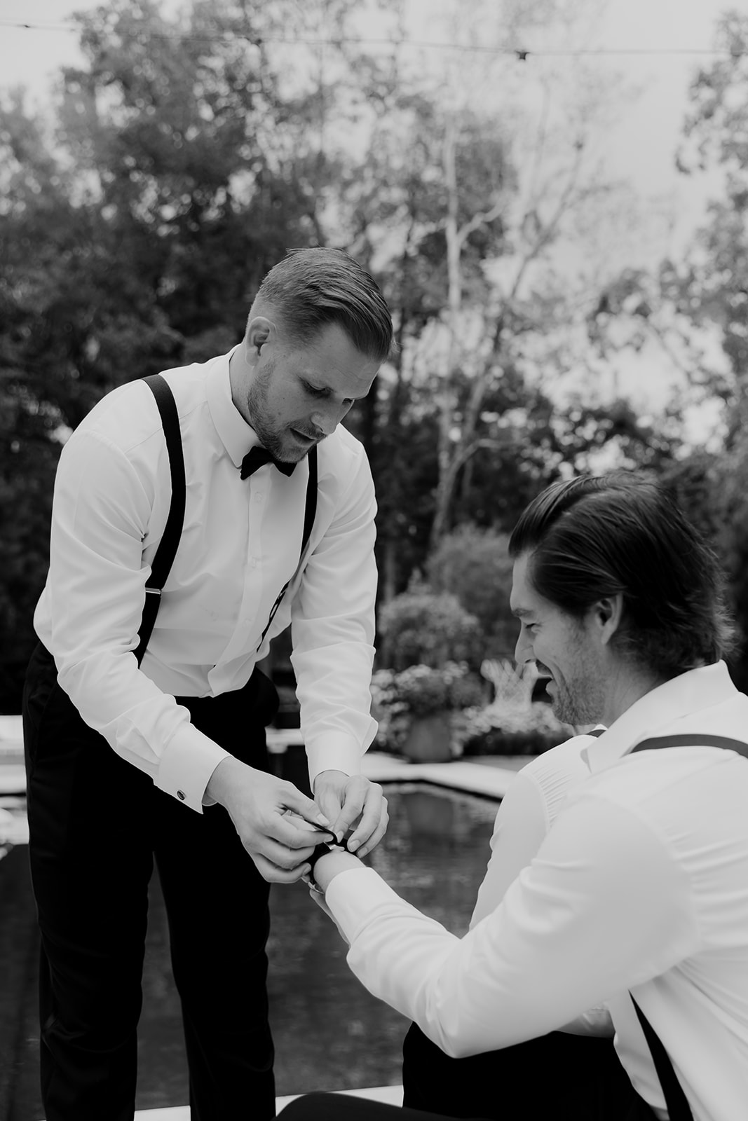 Groom helping Craig Conover to put on watch he gifted to all groomsmen before Middleton Place Wedding