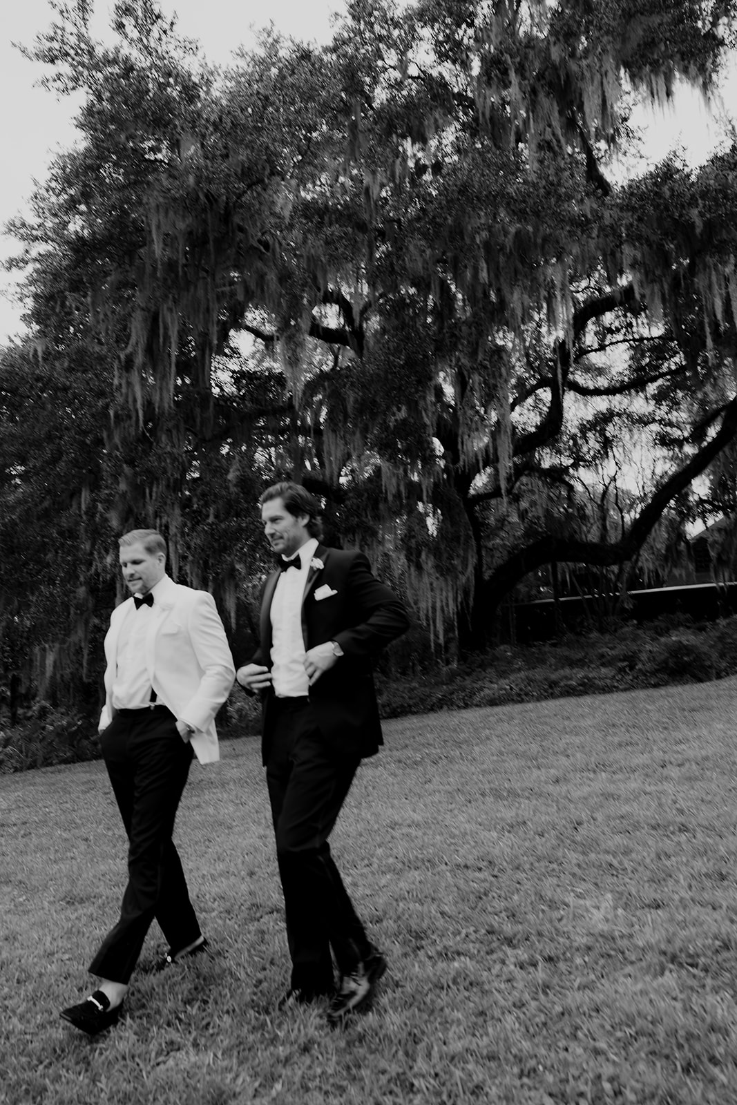 Craig Conover and his brother walking at wedding with live oaks in background