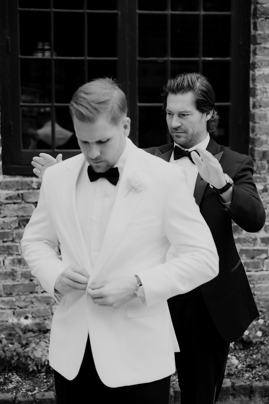 Groom getting ready with help of his best man at Middleton Place Wedding