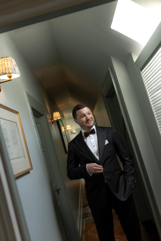 Groom getting ready at Post House Inn for wedding ceremony