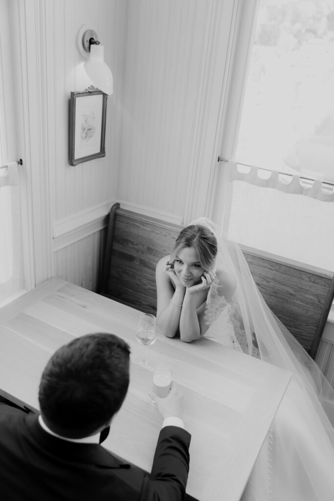 Wedding Couple sitting opposite to each other enjoying a drink at the Post House Inn
