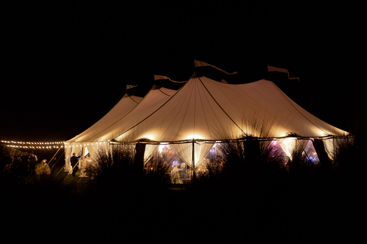 Illuminated sailcloth tent at Kiawah wedding celebration during full moon in spring