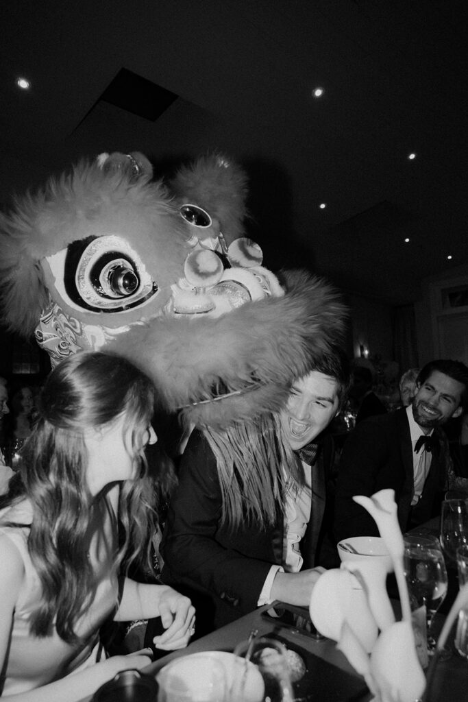 Wedding guest entertainment by lion dancer at wedding in Charleston