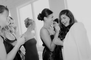 Birde is joking around with bridesmaids at minnesota wedding in St. Paul 