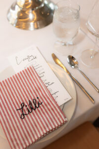 hand embroidered names on italian style red and white napkins 